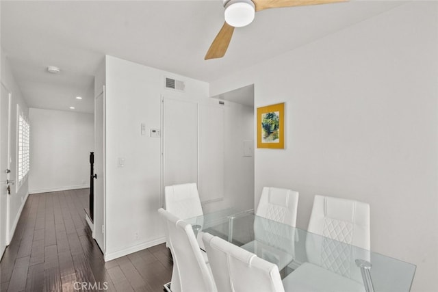 dining space with dark hardwood / wood-style flooring and ceiling fan