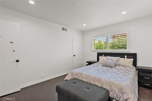 bedroom with dark hardwood / wood-style floors