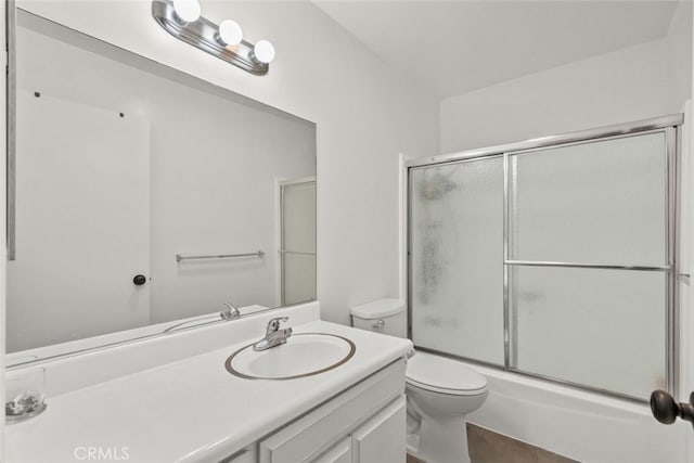 full bathroom with vanity, toilet, and enclosed tub / shower combo