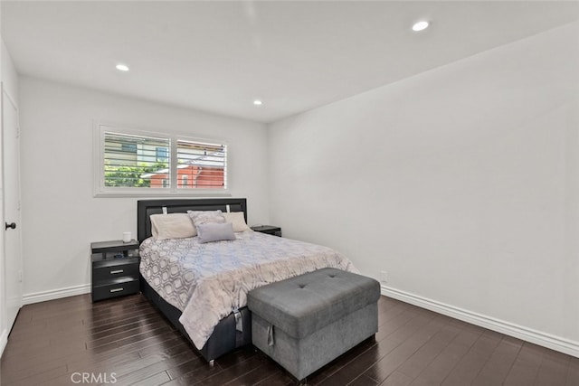 bedroom with dark hardwood / wood-style flooring