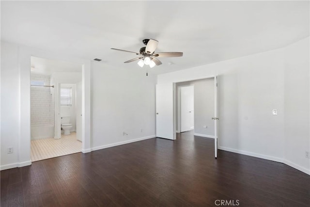 unfurnished room with ceiling fan and dark wood-type flooring