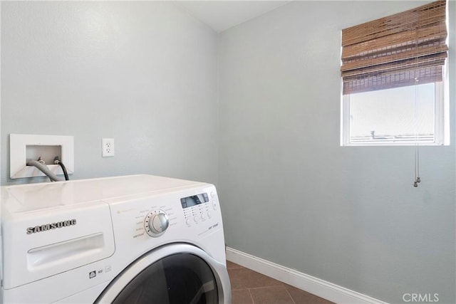 clothes washing area with dark tile patterned flooring and washing machine and clothes dryer