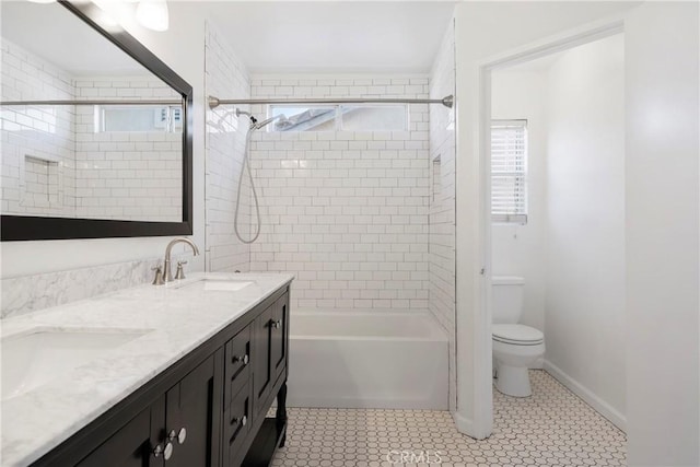 full bathroom with tile patterned floors, vanity, toilet, and tiled shower / bath