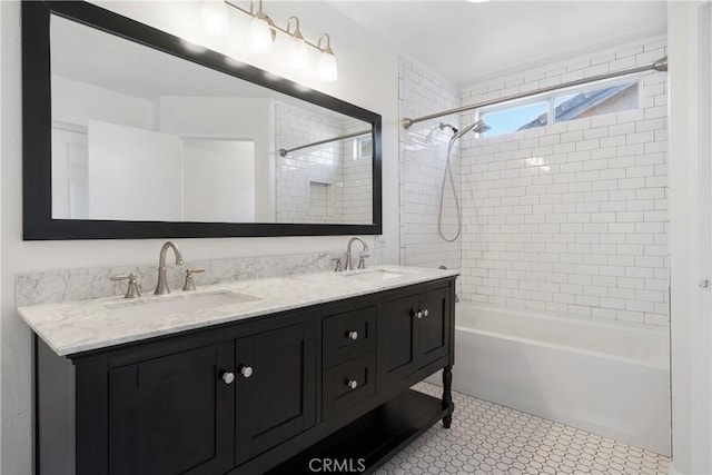 bathroom featuring tile patterned flooring, vanity, and tiled shower / bath