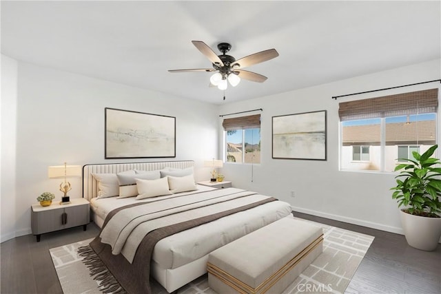 bedroom with ceiling fan and dark hardwood / wood-style floors