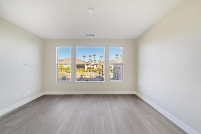 spare room with light wood-type flooring