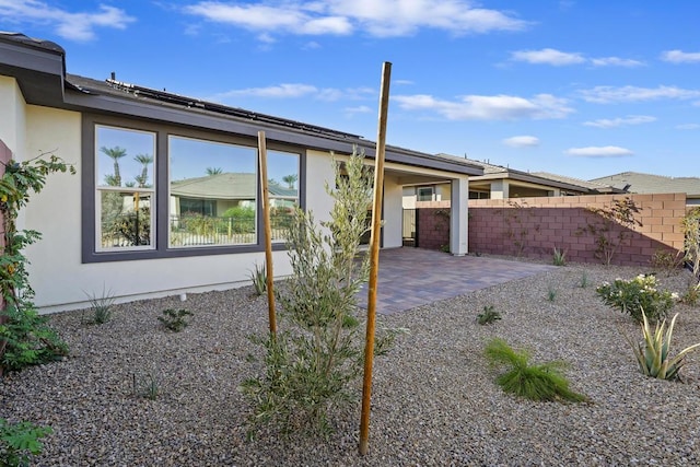 view of side of property featuring a patio