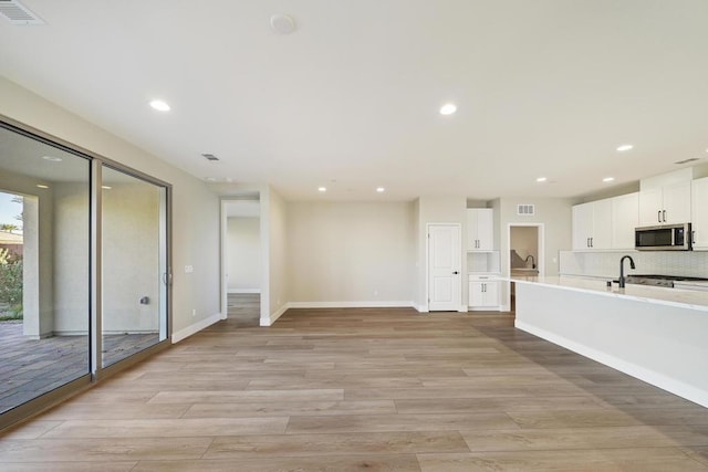 unfurnished living room with light hardwood / wood-style flooring