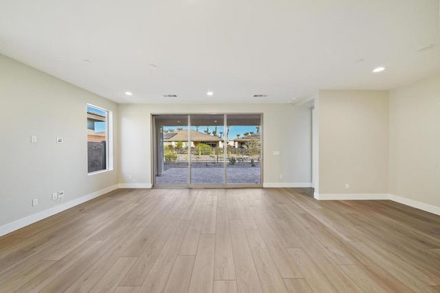 empty room with light hardwood / wood-style flooring