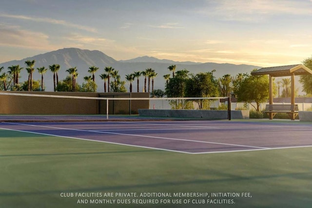 view of sport court featuring a mountain view and basketball hoop