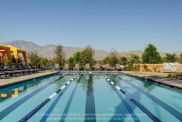 view of swimming pool featuring a mountain view and a patio area