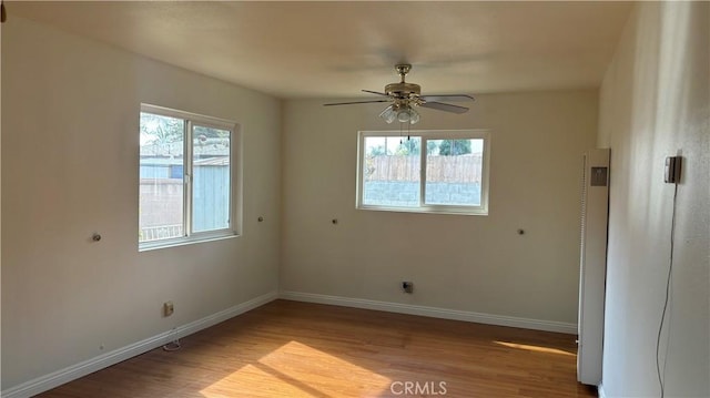 empty room with ceiling fan and light wood-type flooring