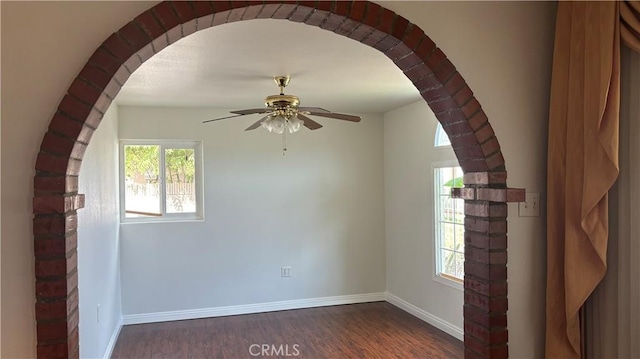 unfurnished room with dark hardwood / wood-style floors and ceiling fan