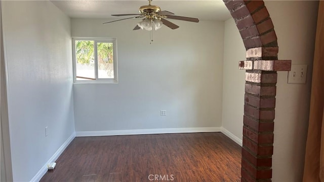 spare room featuring ceiling fan and dark wood-type flooring