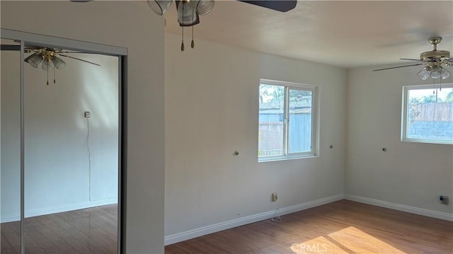 empty room with hardwood / wood-style flooring and a healthy amount of sunlight