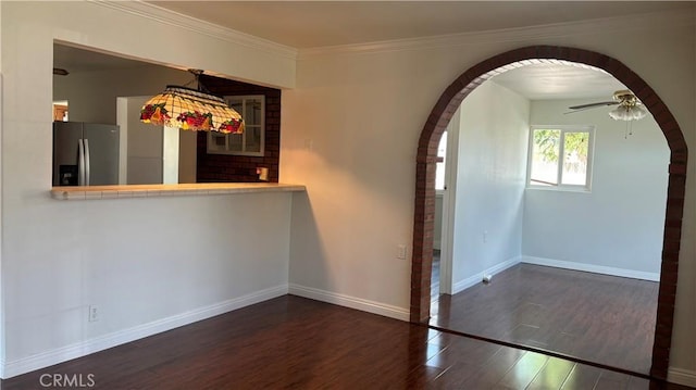 interior space with ceiling fan, crown molding, and dark wood-type flooring