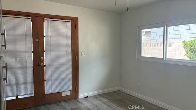 doorway with french doors and light hardwood / wood-style flooring