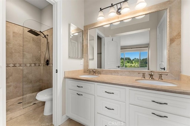 bathroom featuring tiled shower, vanity, toilet, and tile patterned flooring