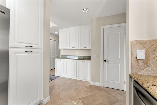 kitchen featuring white cabinets, dishwasher, light stone countertops, and light tile patterned floors