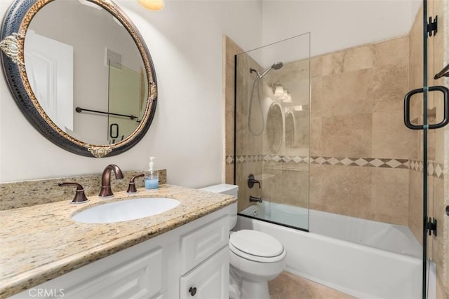 full bathroom with shower / bath combination with glass door, vanity, and toilet