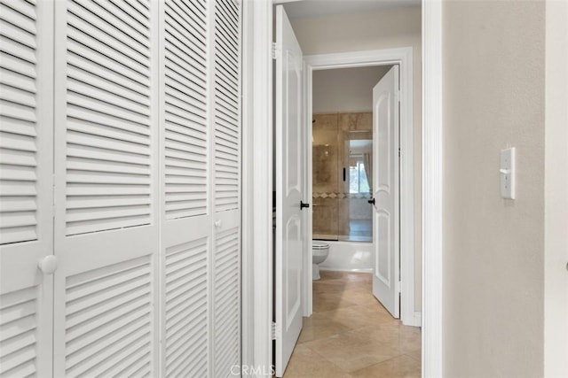 hall featuring light tile patterned floors