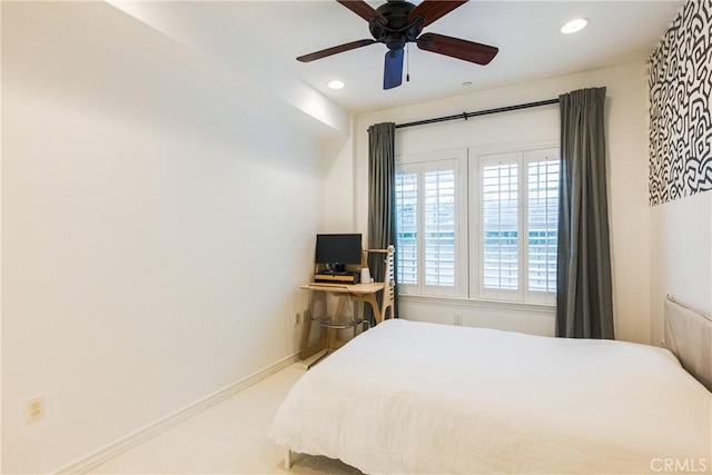 bedroom with ceiling fan and light colored carpet