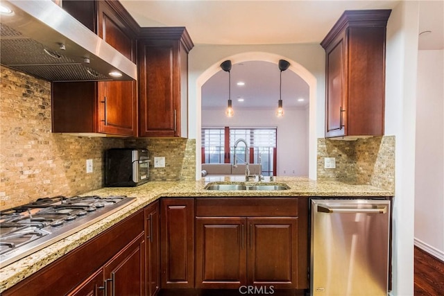 kitchen featuring wall chimney exhaust hood, decorative backsplash, sink, and stainless steel appliances