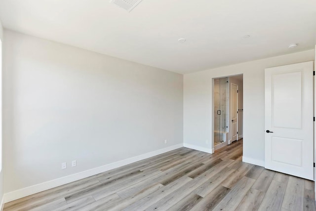 empty room with light hardwood / wood-style floors