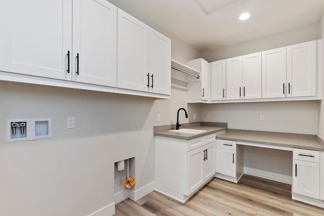 laundry room with cabinets, sink, light hardwood / wood-style floors, and washer hookup