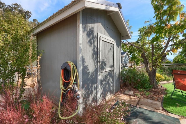 view of side of home with a shed