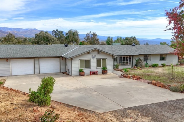 single story home with a mountain view and a garage