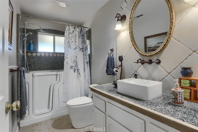 bathroom with tile patterned floors, vanity, and toilet