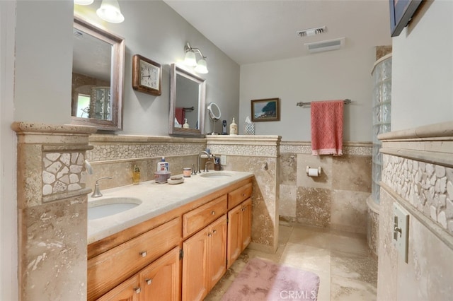 bathroom with tile patterned flooring, vanity, and tile walls