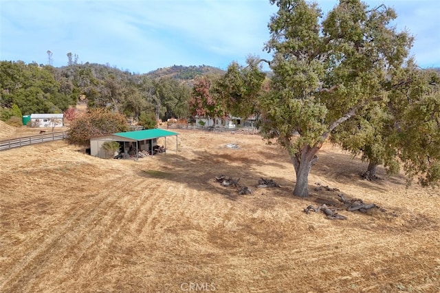 view of yard with an outbuilding and a rural view