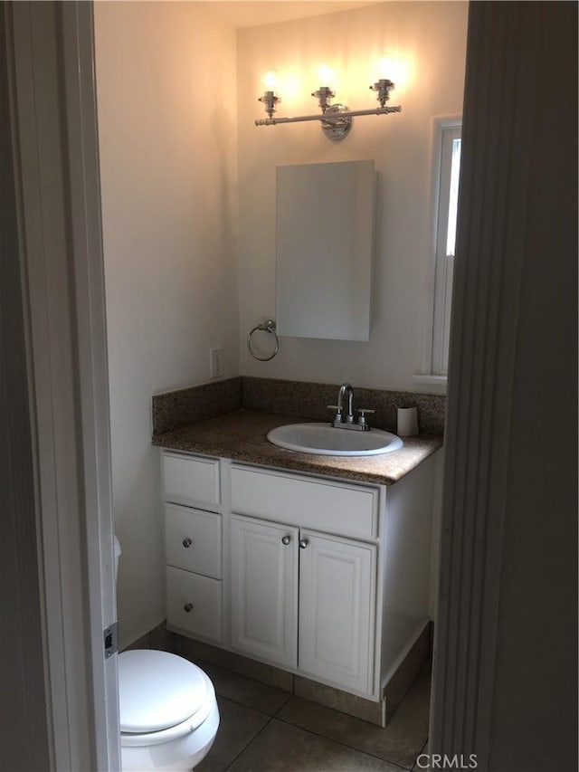 bathroom featuring tile patterned flooring, vanity, and toilet