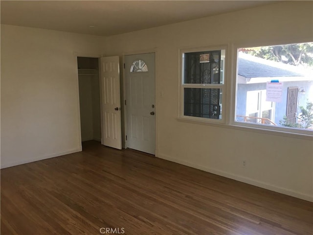 spare room with dark hardwood / wood-style floors