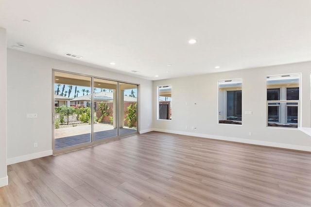 unfurnished room with light wood-type flooring