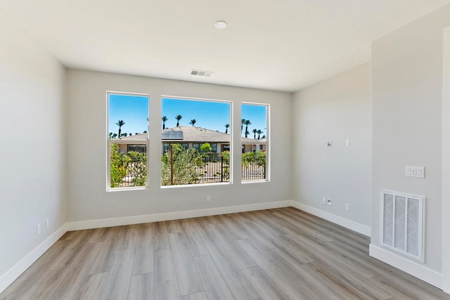 unfurnished room with light hardwood / wood-style floors