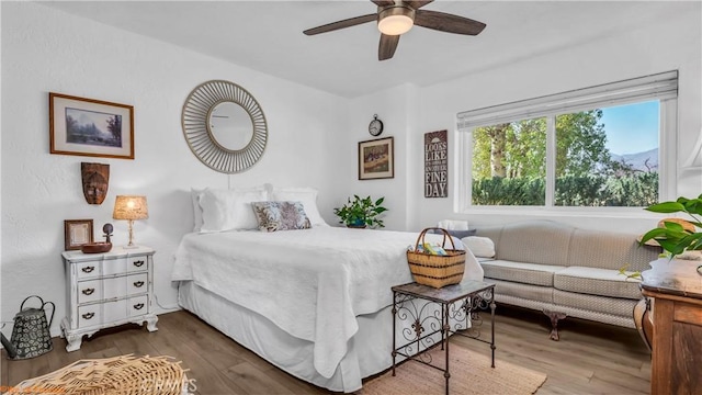 bedroom featuring dark wood-type flooring and a ceiling fan