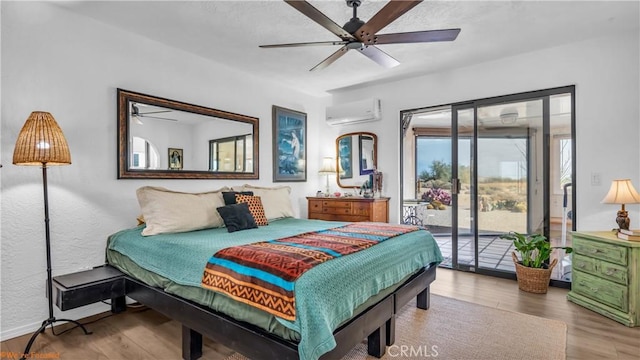 bedroom featuring wood finished floors, a ceiling fan, baseboards, access to outside, and an AC wall unit