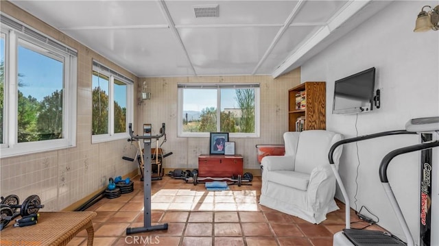 exercise room with tile patterned flooring and visible vents