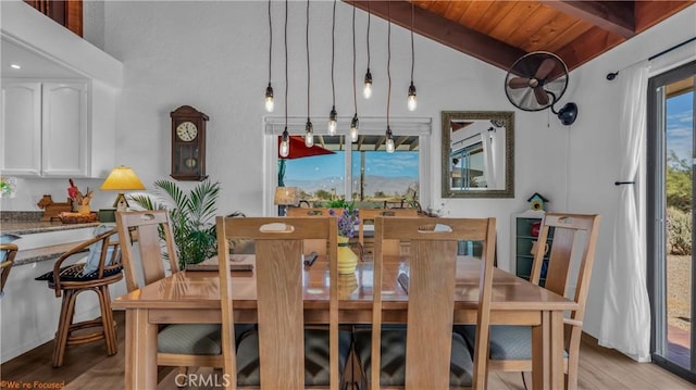 dining area with wood ceiling, lofted ceiling with beams, and light wood-style flooring