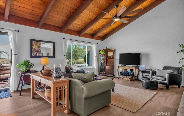 living area featuring vaulted ceiling with beams, a textured wall, light wood-style floors, a ceiling fan, and wood ceiling