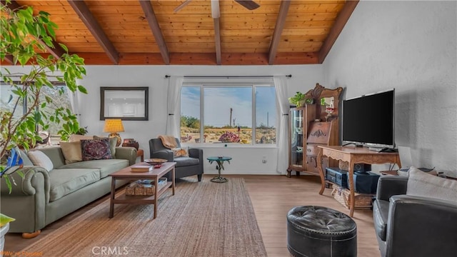 living area with lofted ceiling with beams, light wood-style floors, wood ceiling, and ceiling fan