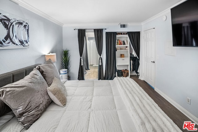 bedroom featuring wood-type flooring and ornamental molding