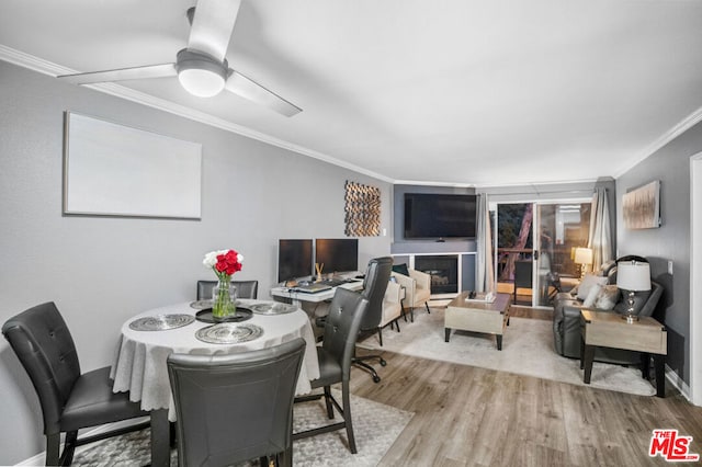 dining room featuring crown molding, ceiling fan, and hardwood / wood-style flooring