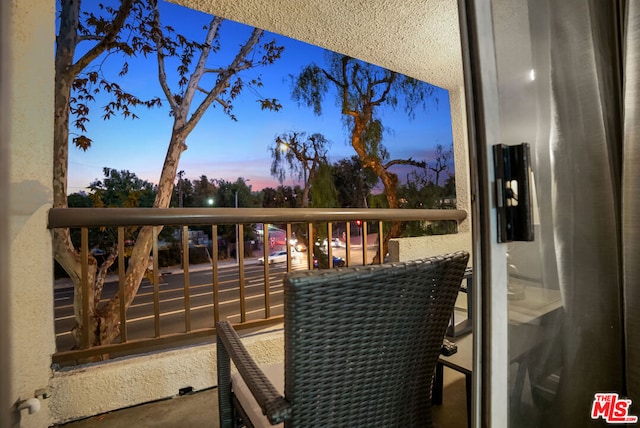 view of balcony at dusk