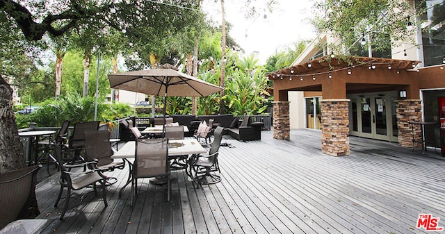 wooden terrace featuring an outdoor living space