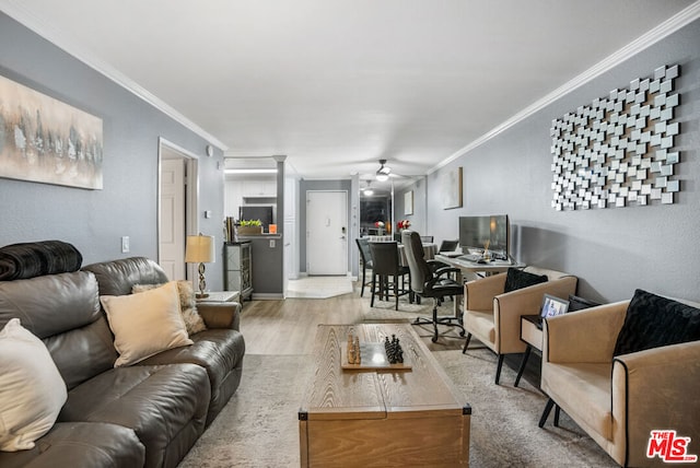 living room featuring hardwood / wood-style flooring, ceiling fan, and crown molding