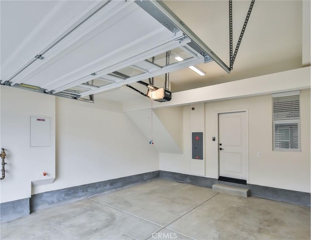 garage featuring electric panel and a garage door opener